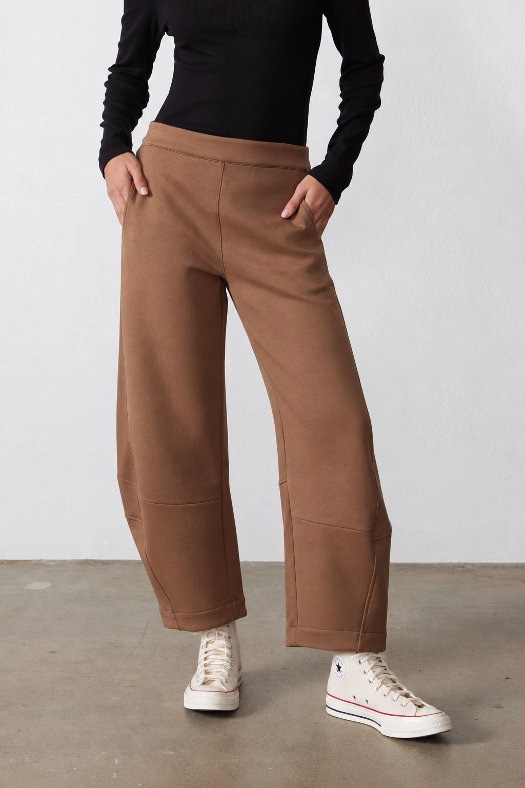 Mocha work scuba pants with elastic waist, side pockets, relaxed ankle-length silhouette