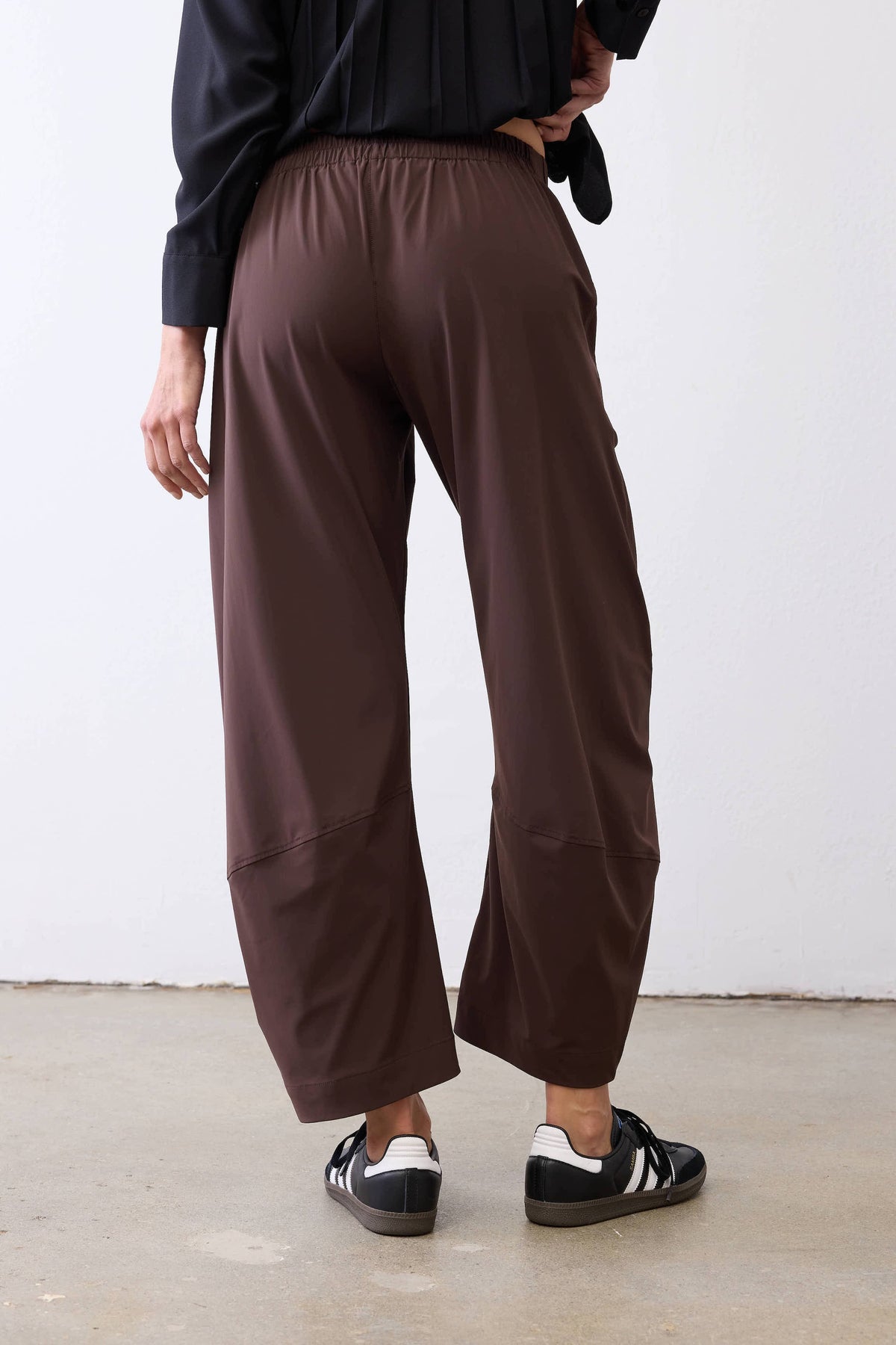 Coffee-brown work pants back view: elastic waistband, relaxed wide-leg silhouette.