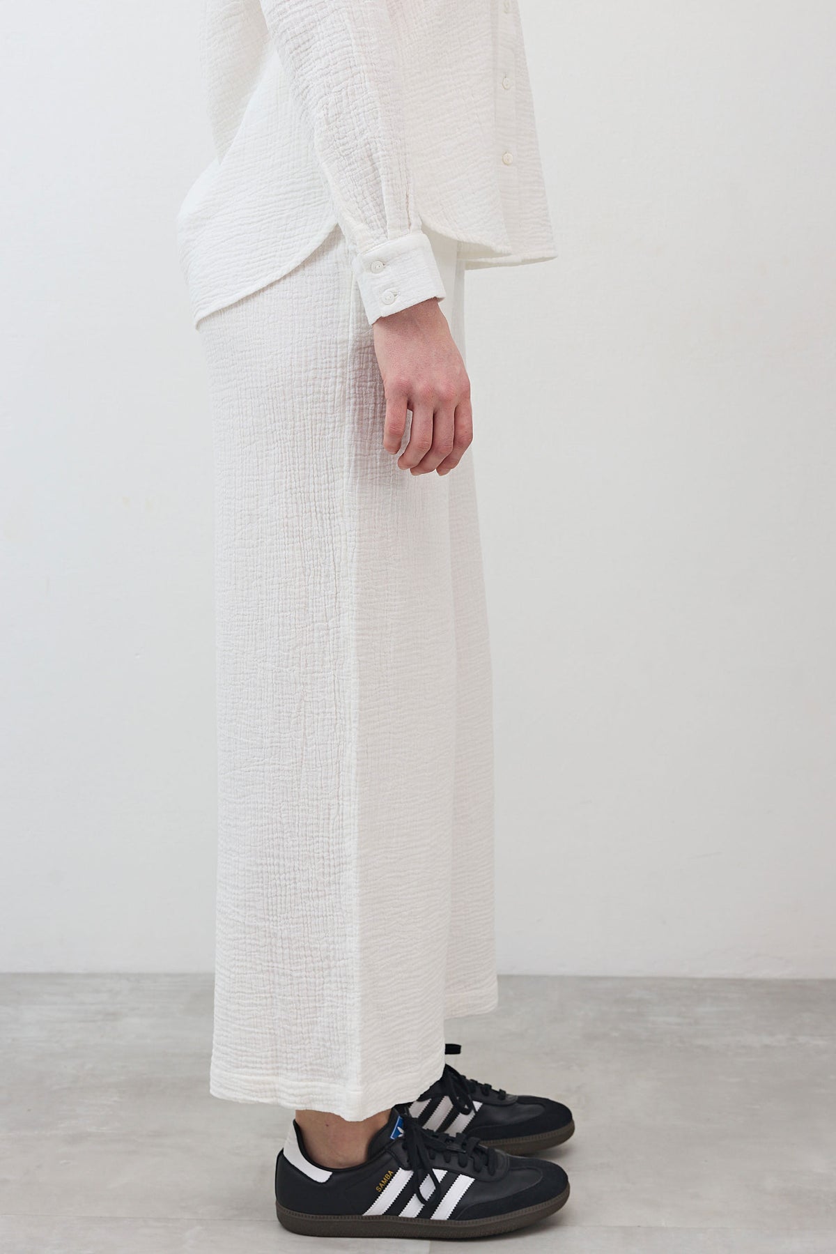 Marshmallow wide-leg pants showing side view, textured fabric with straight wide leg