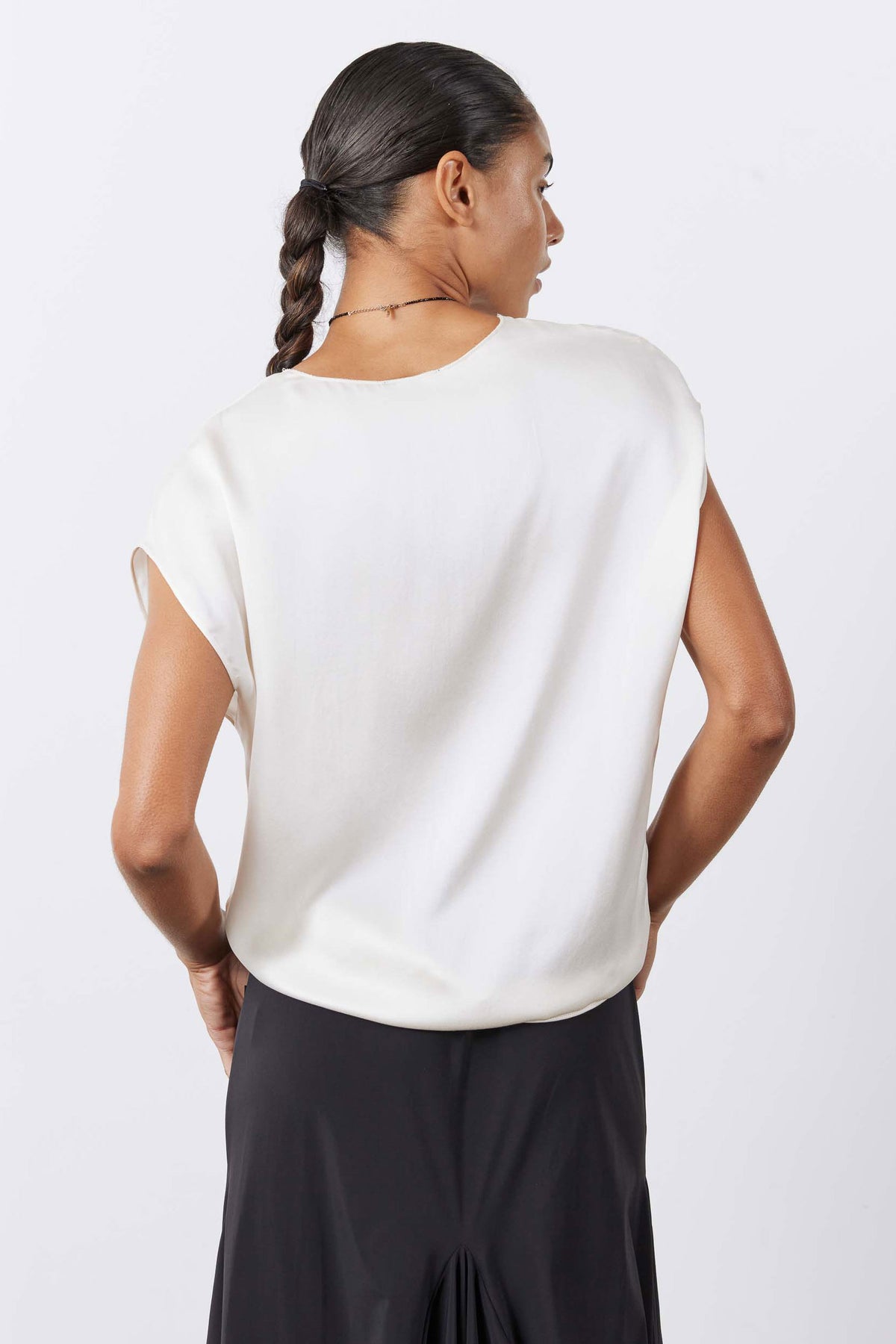 Cream silk V-neck sleeveless top, back view with smooth drape