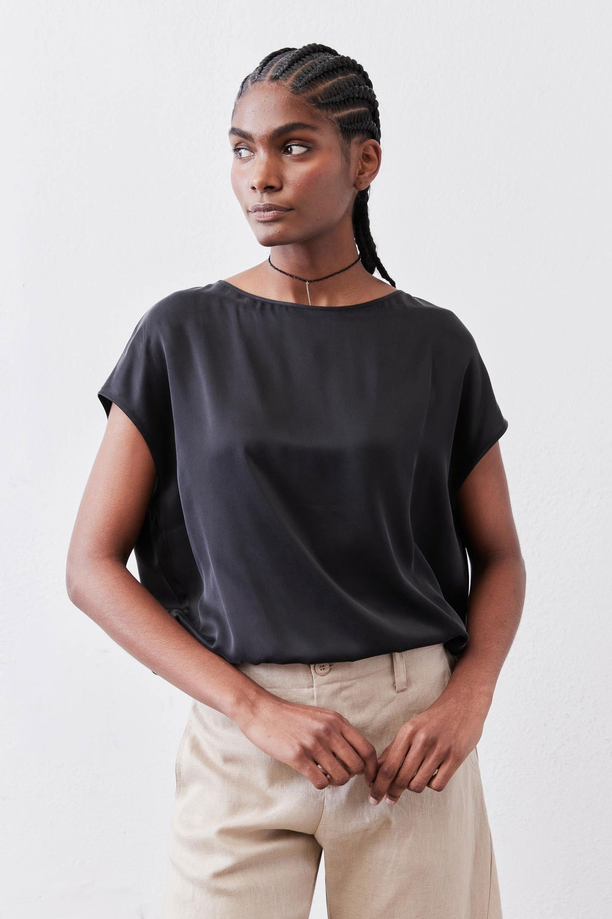 Black silk short-sleeve blouse with relaxed fit and rounded neckline