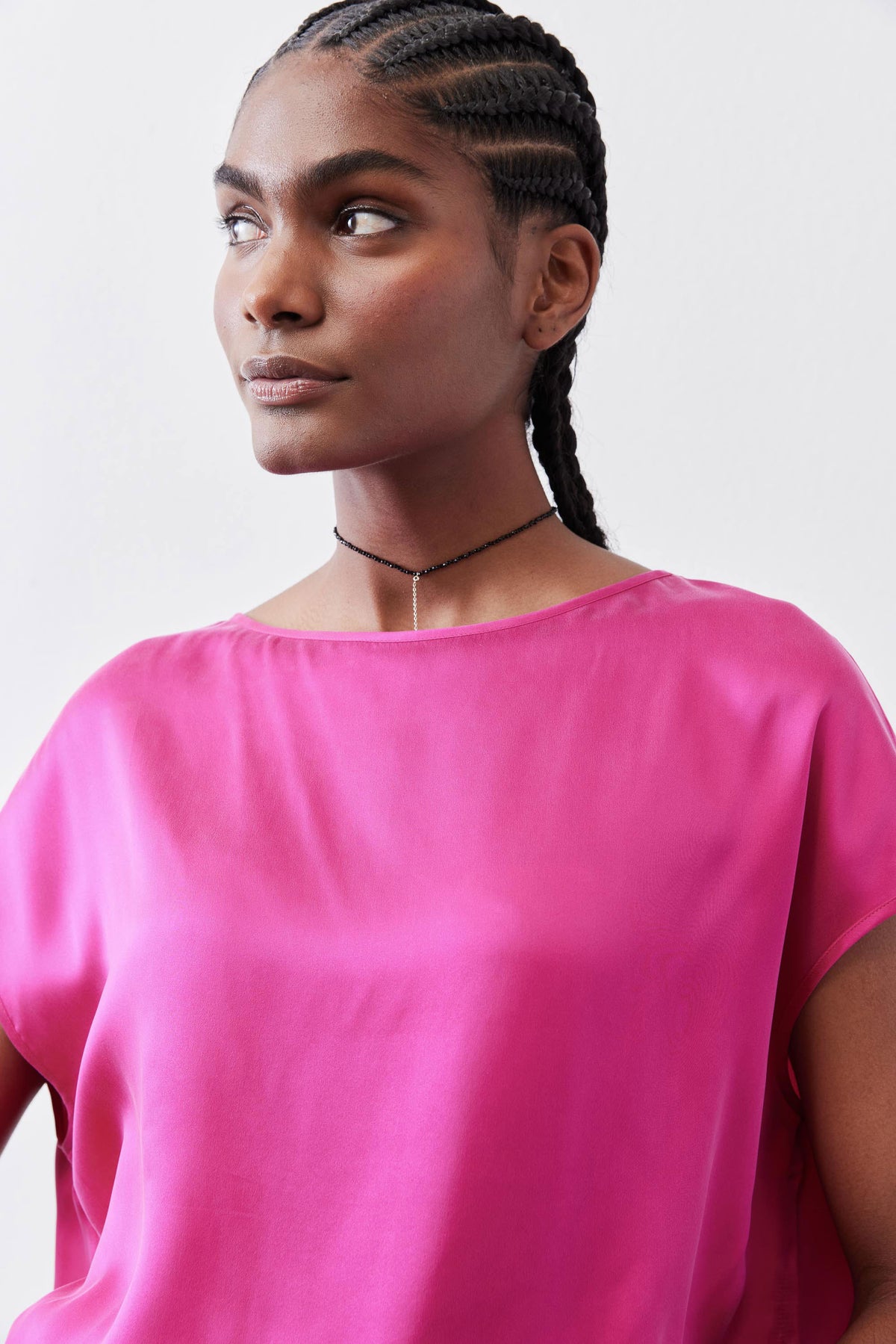 Fuchsia silk blouse with crew neckline and soft drape, upper-body view