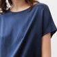 Close-up of deep blue silk blouse with crew neckline and short sleeves