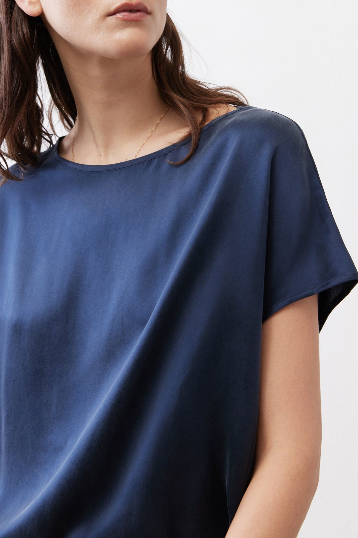Sky blue silk blouse with crew neckline and short sleeves