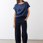 Deep blue silk blouse with cap sleeves, crew neck, relaxed drape over jeans