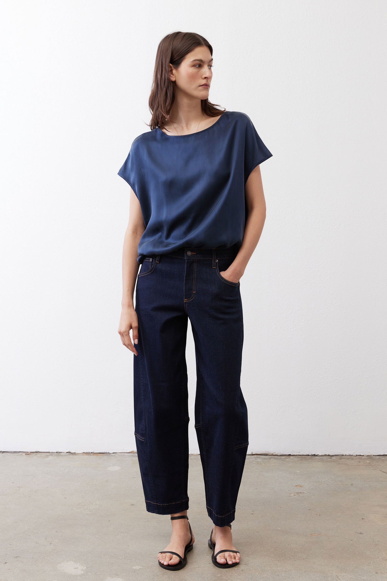 Deep blue silk blouse with cap sleeves, crew neck, relaxed drape over jeans