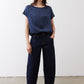 Deep blue silk blouse with short sleeves and crew neck, worn with jeans