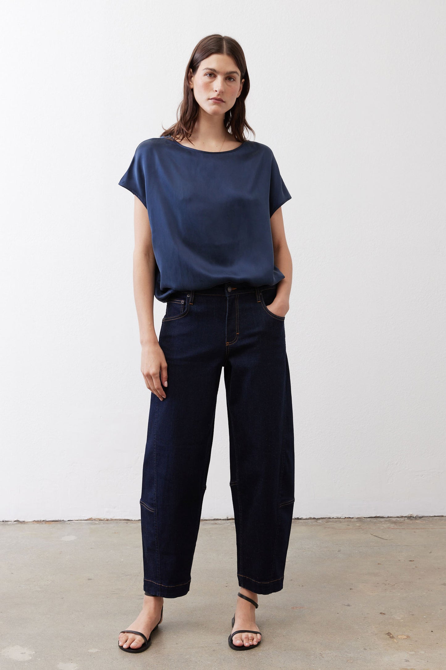 Deep blue silk blouse with short sleeves and crew neck, worn with jeans