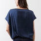 Back view of deep blue silk blouse with short sleeves and crew neckline