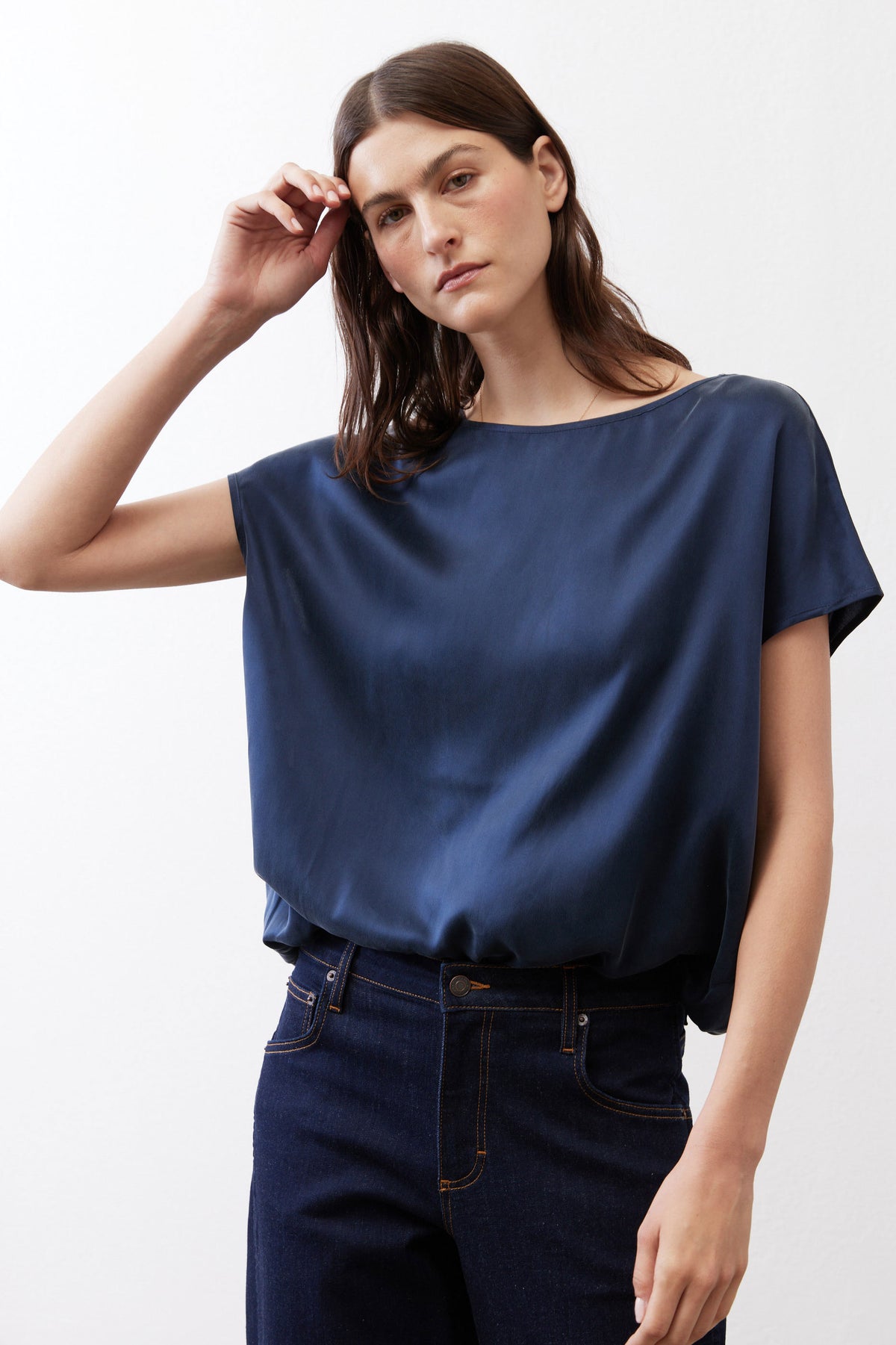 Sky blue silk blouse with crew neck and short sleeves, relaxed draped silhouette