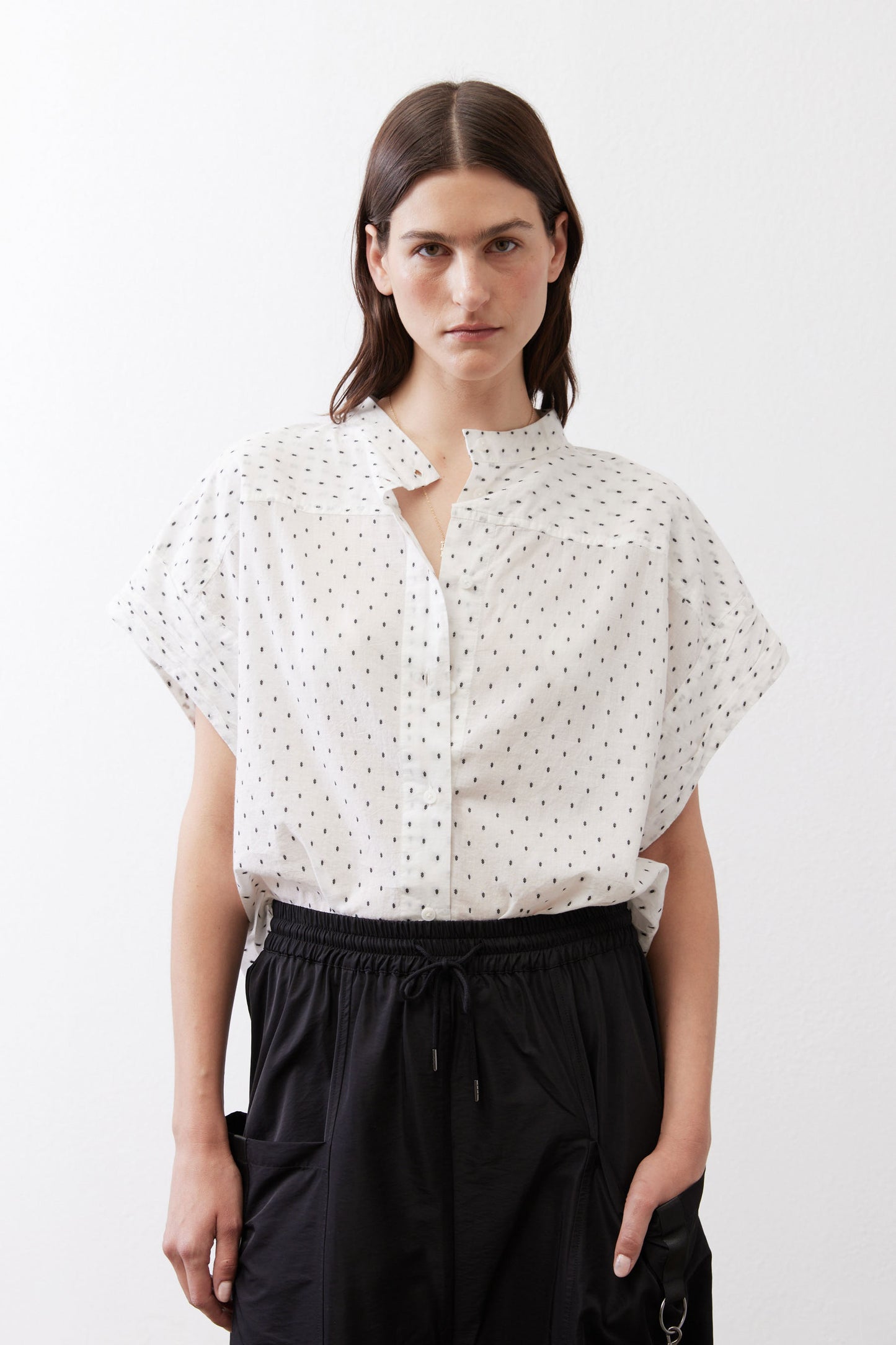 White blouse with small black dot print, button-front and short dolman sleeves