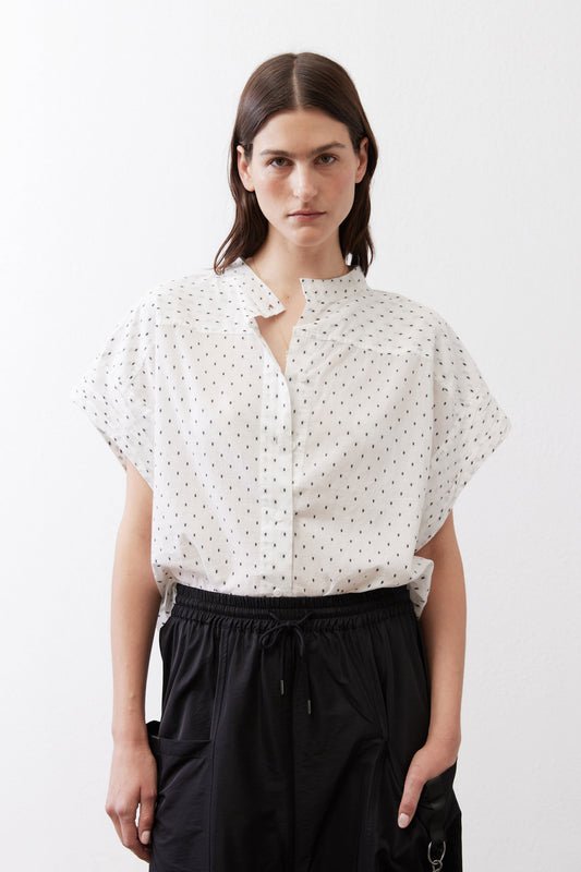 White blouse with small black dot print, button-front and short dolman sleeves