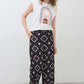 White sleeveless graphic tee with rainbow arch print at the front