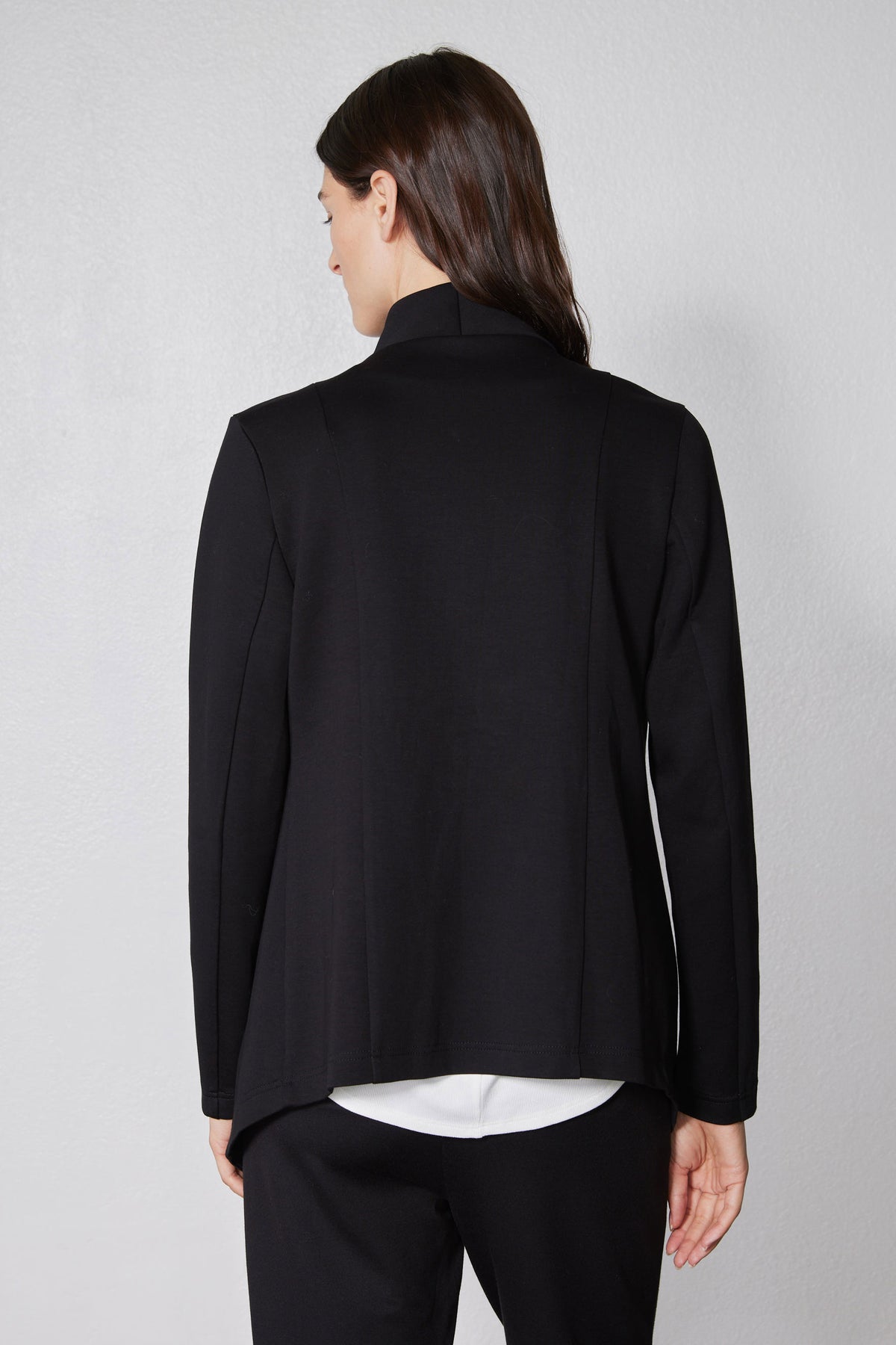 Back view of black asymmetric scuba jacket with stand collar and long sleeves
