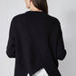 Black asymmetric pullover sweater back with diagonal drape and white layered underhem