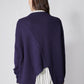 Asymmetric pullover sweater in deep purple, back view with diagonal seam and ribbed cuffs