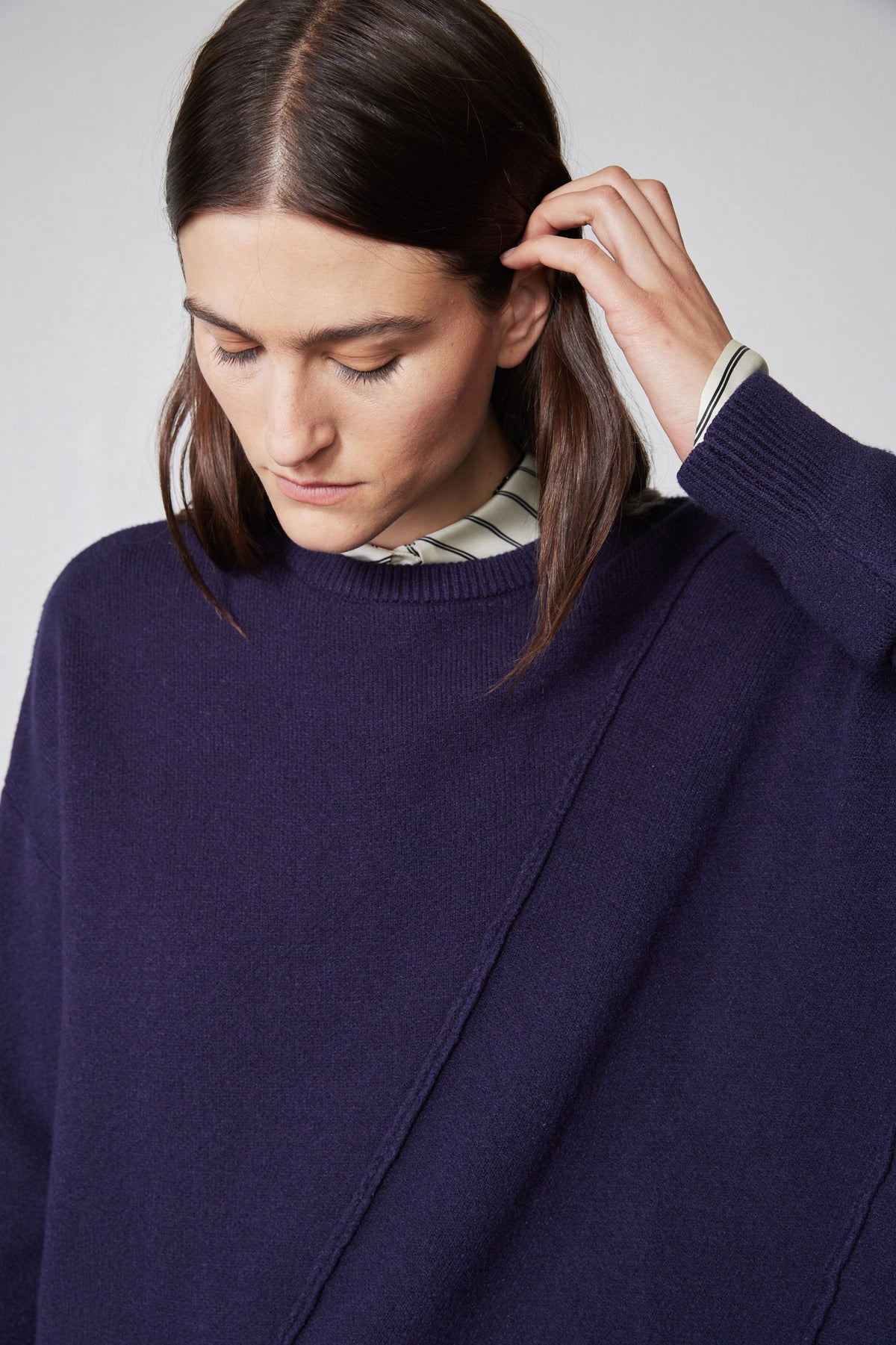 Asymmetric pullover sweater deep purple with diagonal seam, ribbed collar and cuff detail