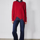 Red asymmetric pullover sweater with angled panel detail and crew neck