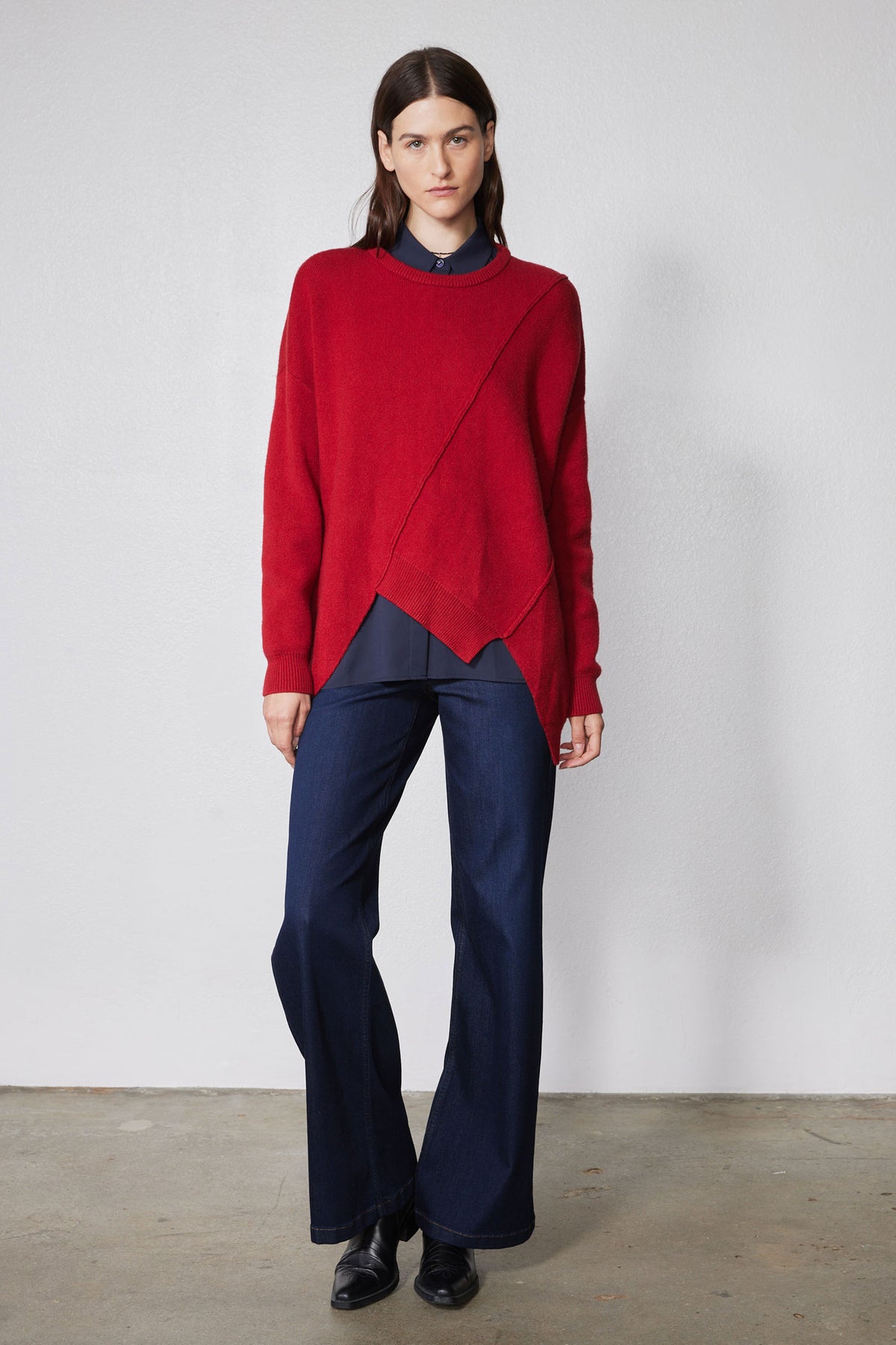 Red asymmetric pullover sweater with angled panel detail and crew neck