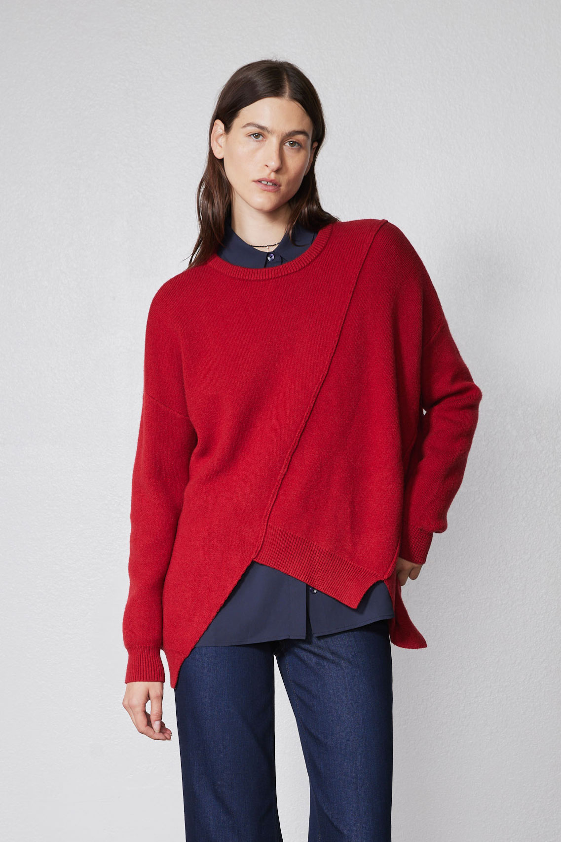 Red asymmetric pullover sweater with diagonal front seam and ribbed crew neck