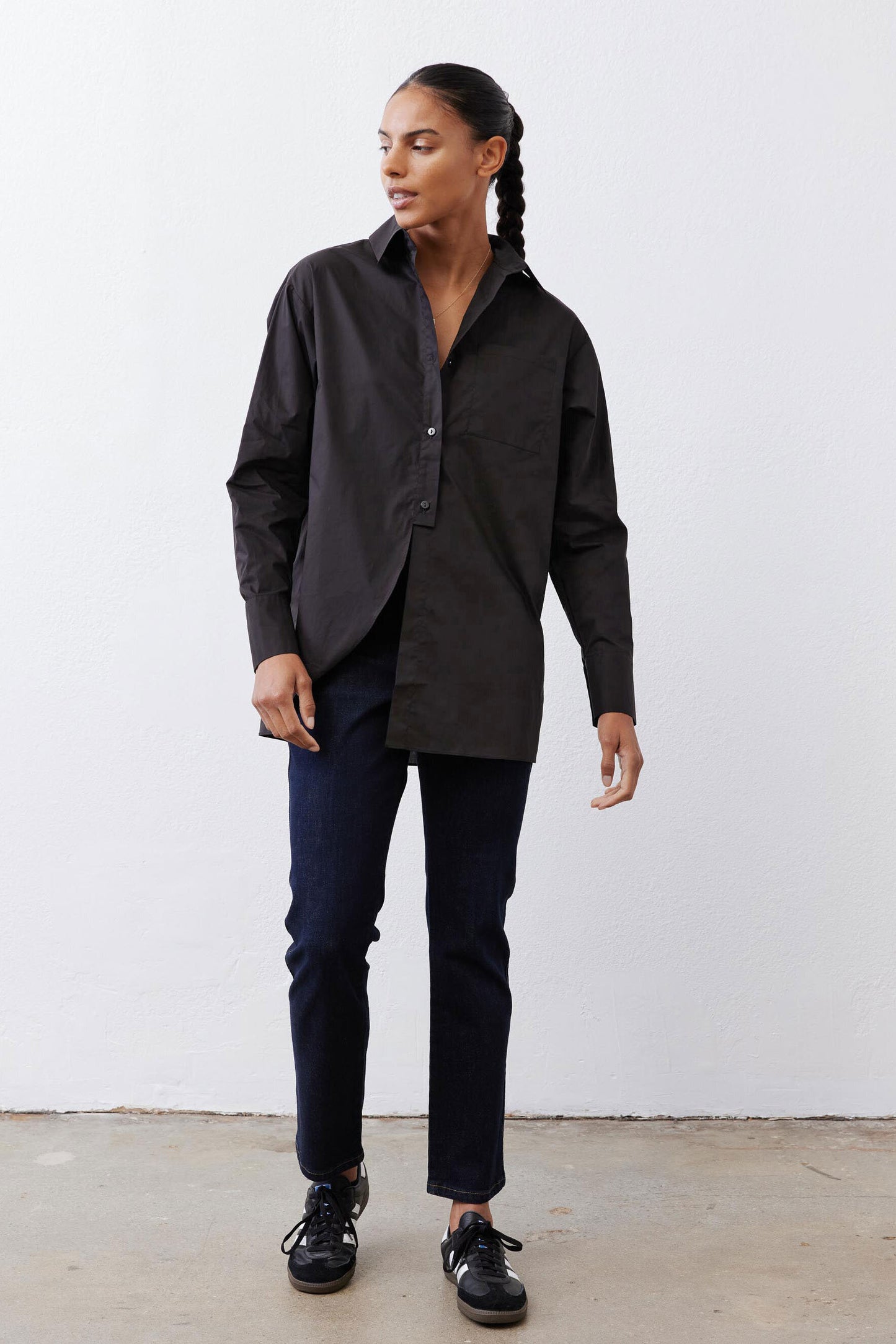 Black asymmetric button-down shirt with pointed collar and front buttons