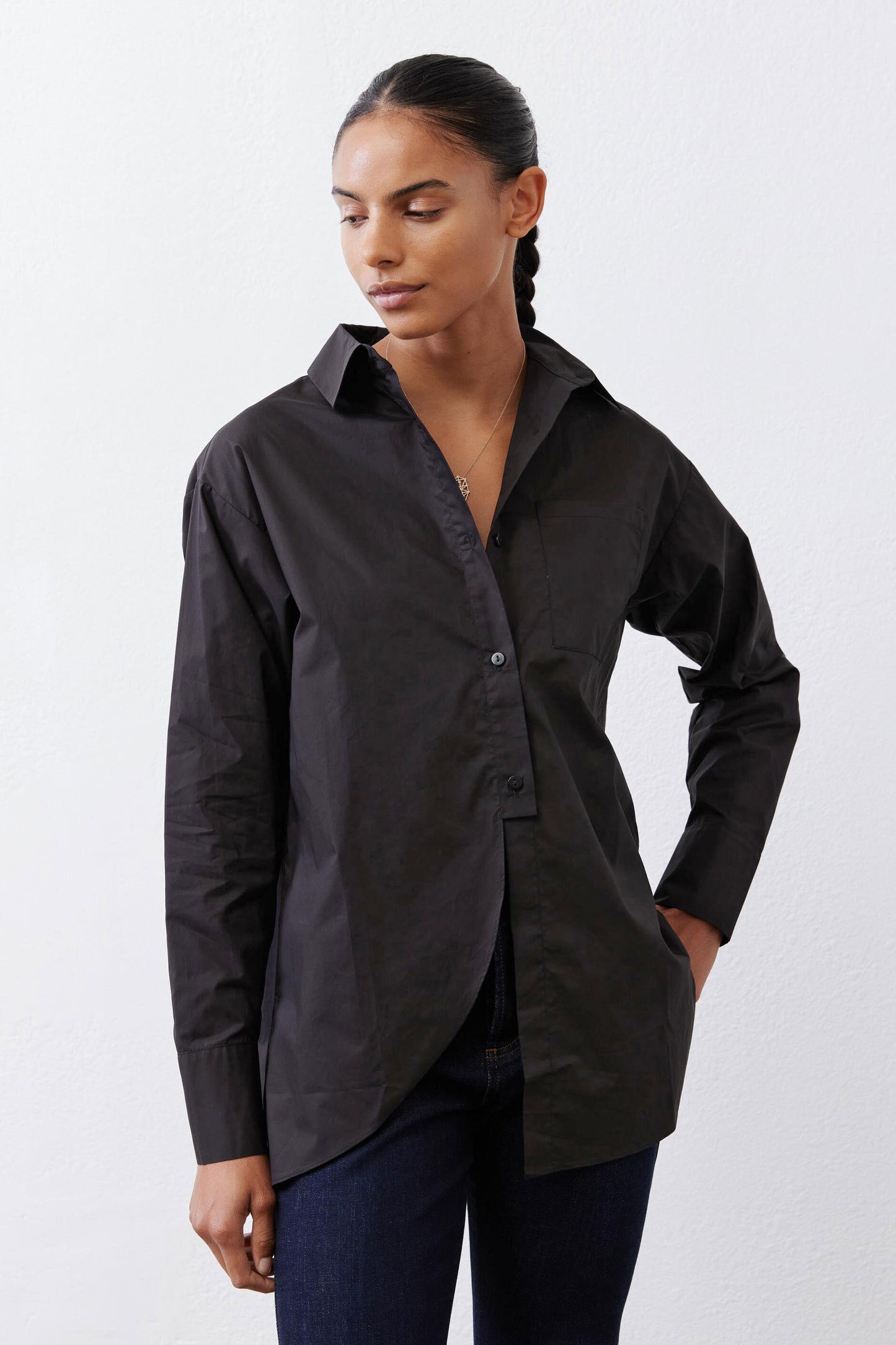 Black asymmetric button-down shirt with side drape and long cuffed sleeves
