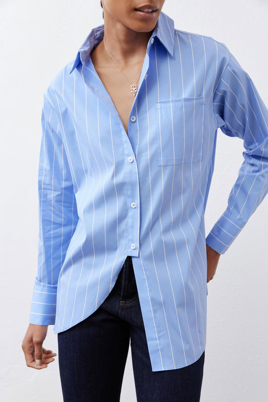 Close-up of light blue striped button-down shirt front with V-neck opening
