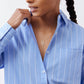 Detail view of light blue striped button-down collar with front buttons