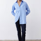 Light blue striped button-down shirt with asymmetric pulled hem