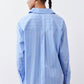 Back view of light blue striped button-down shirt with yoke and button cuffs