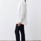 White asymmetric button-down shirt, long sleeves and pointed collar, side profile