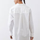 White asymmetric button-down shirt from back, long sleeves and pointed collar