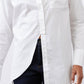 White asymmetric button-down shirt close-up with front split and chest pocket