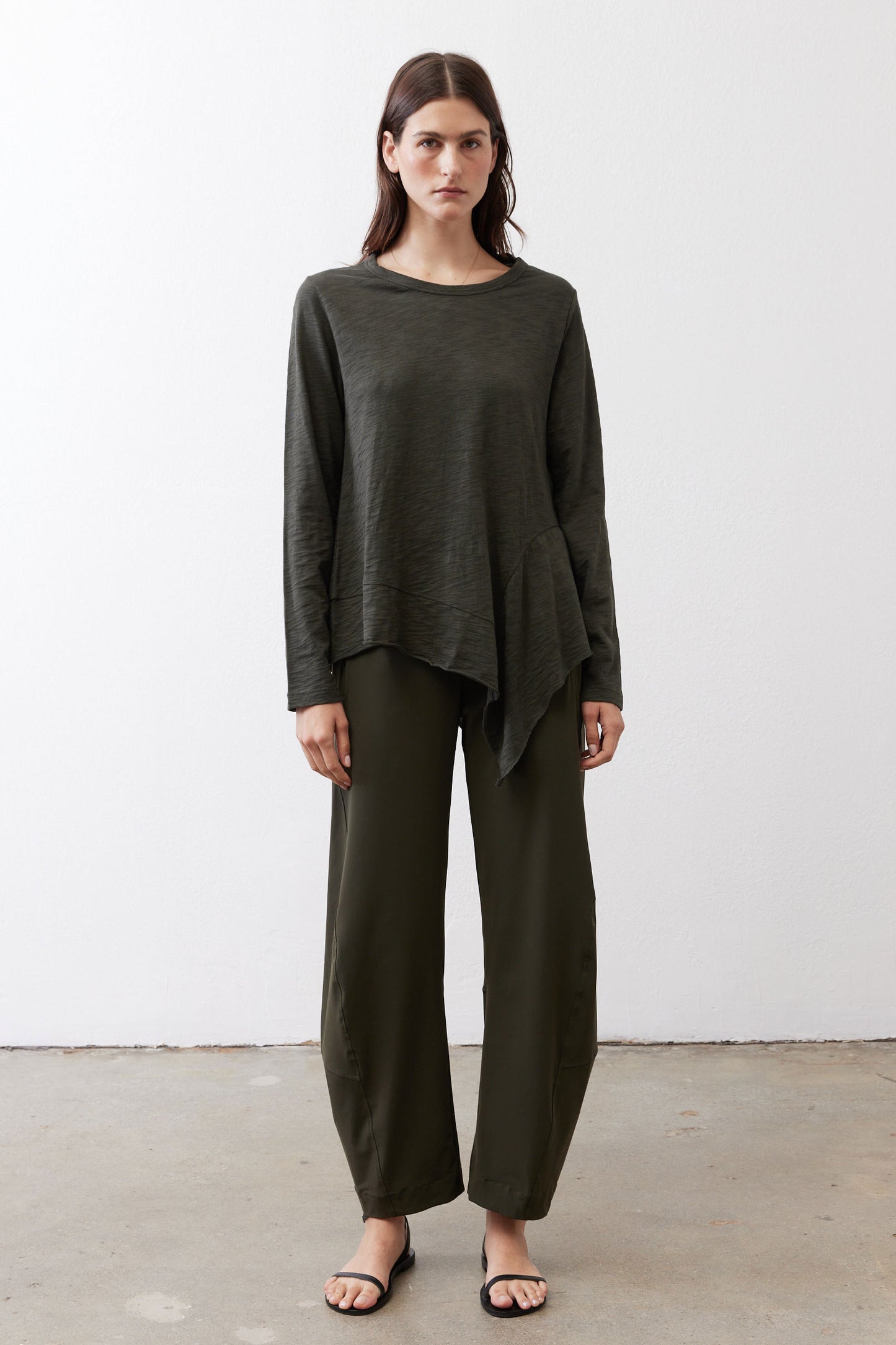 Asymmetric long-sleeve tunic in dark forest green with uneven hemline