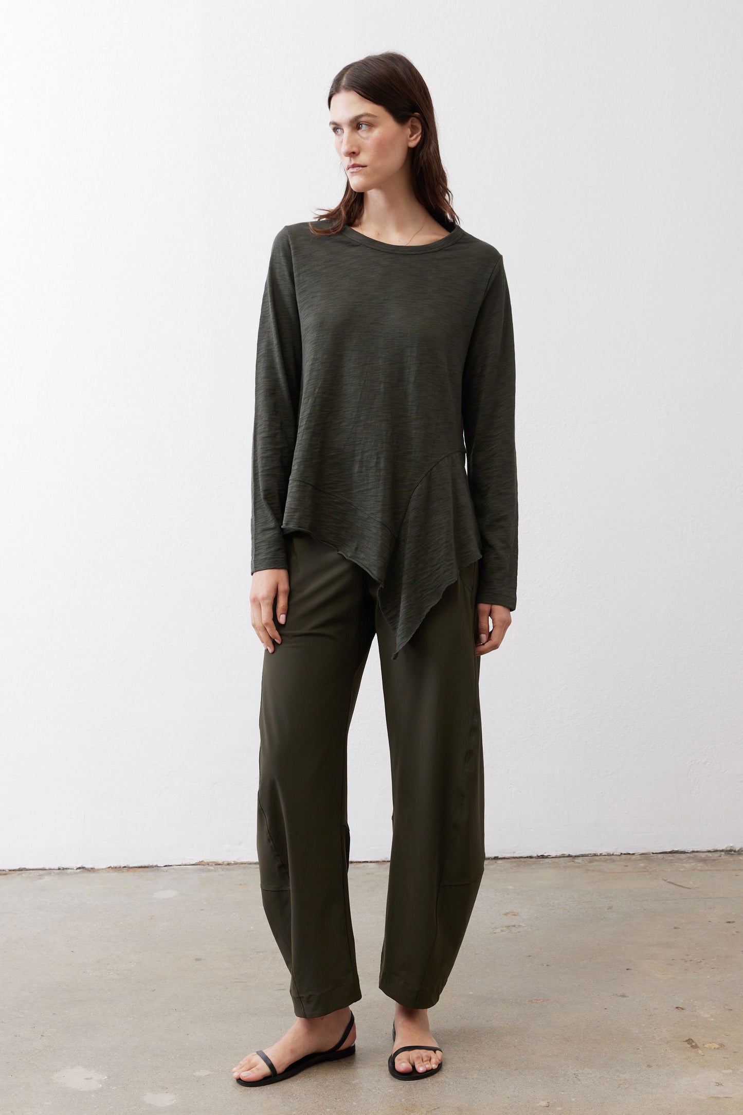 Asymmetric long-sleeve tunic in dark forest green with draped front hem