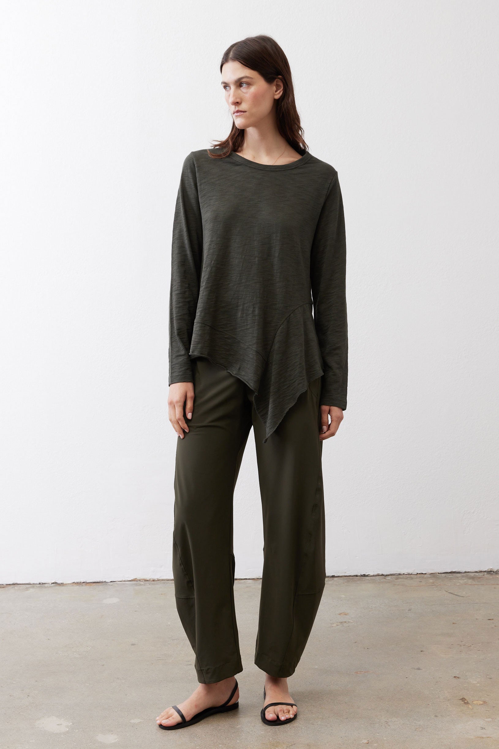 Asymmetric long-sleeve tunic in dark forest green with draped front hem