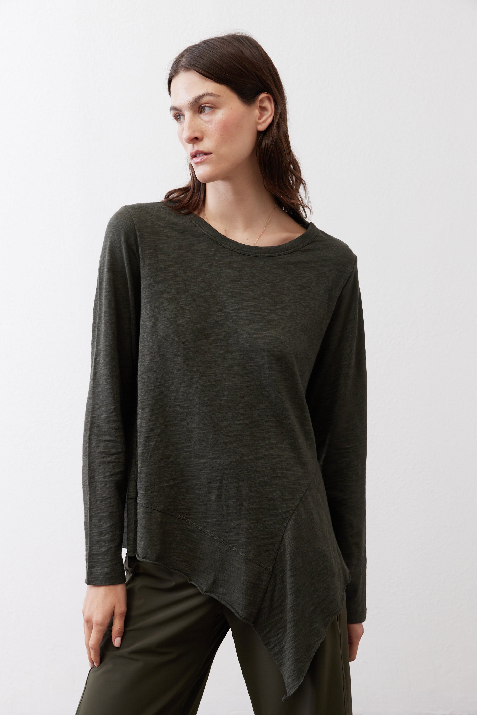 Asymmetric long-sleeve tunic in dark forest green, loose fit and curved side hem