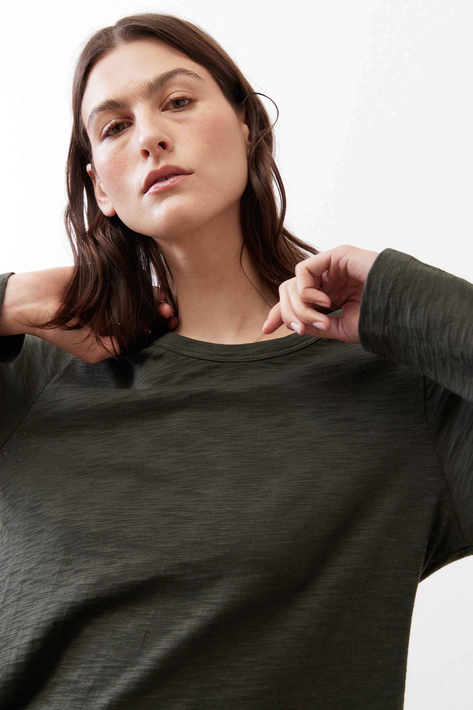 Asymmetric long-sleeve tunic in dark forest green with crew neckline and knit texture