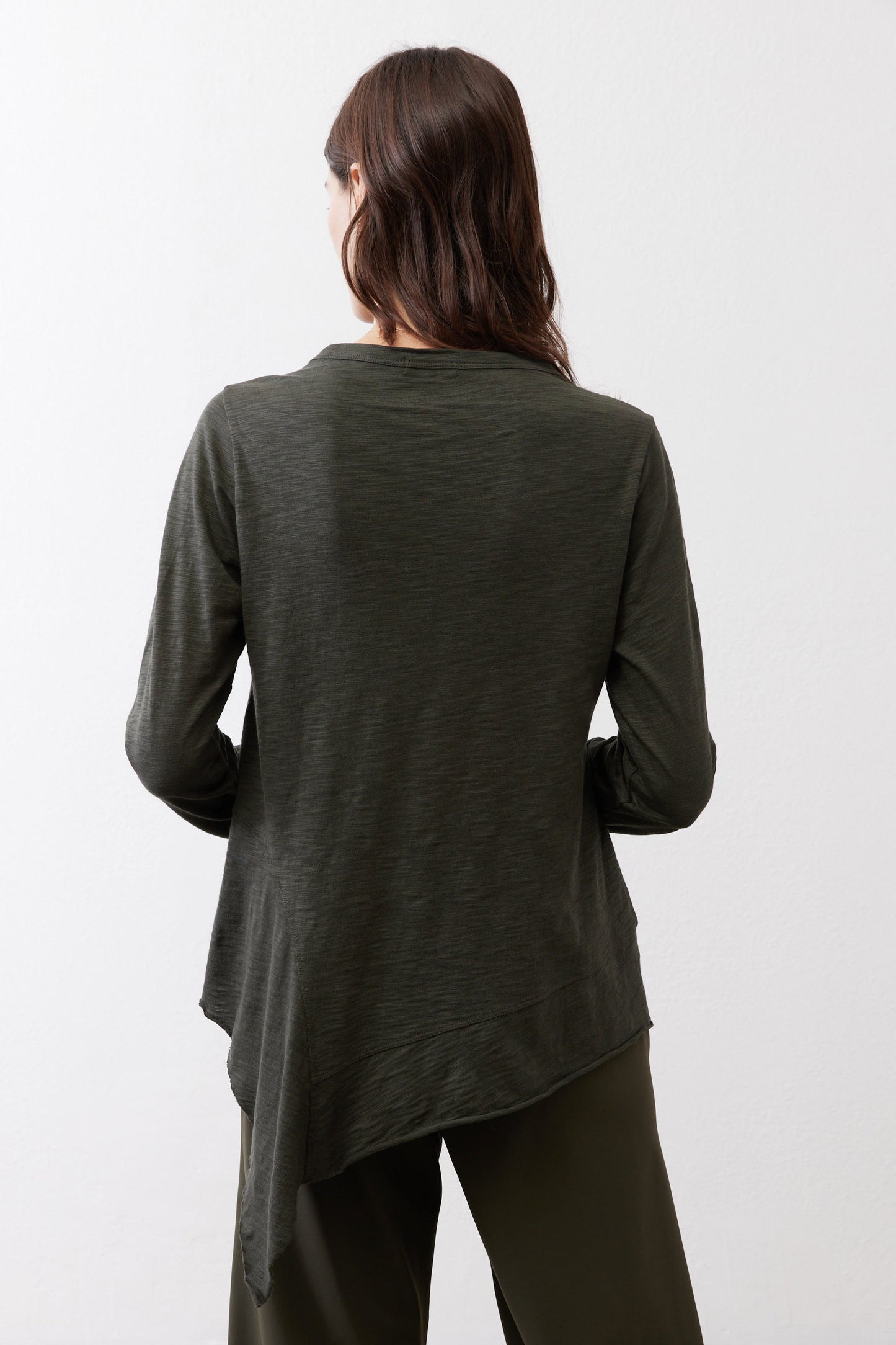 Asymmetric long-sleeve tunic in dark forest green, back view with longer hem