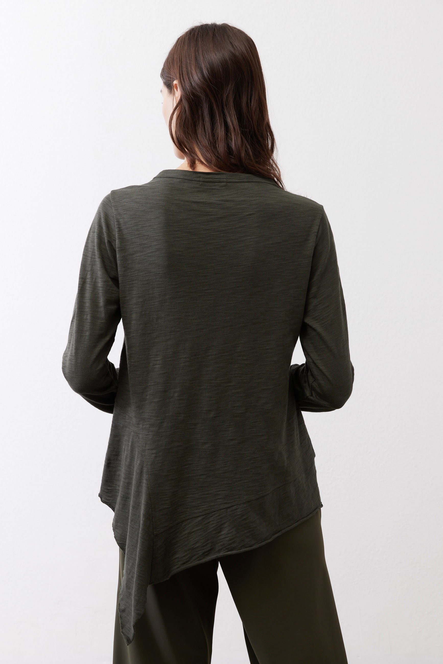 Asymmetric long-sleeve tunic in dark forest green, back view with longer hem