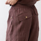 Chicory coffee utility pants with front cargo pocket and brass-look button tabs