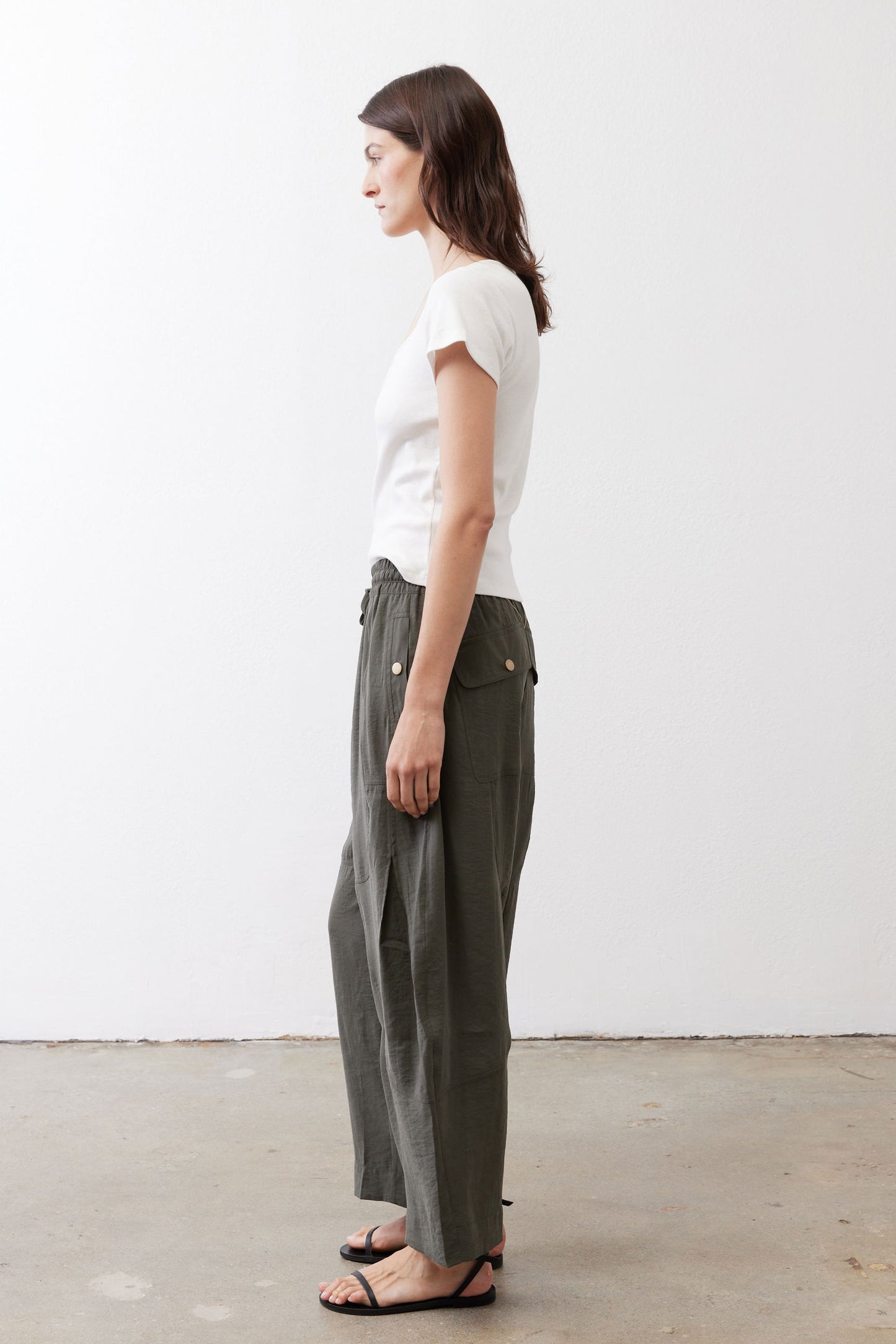 Utility pants, dark olive, drawstring elastic waist and wide relaxed legs, side view