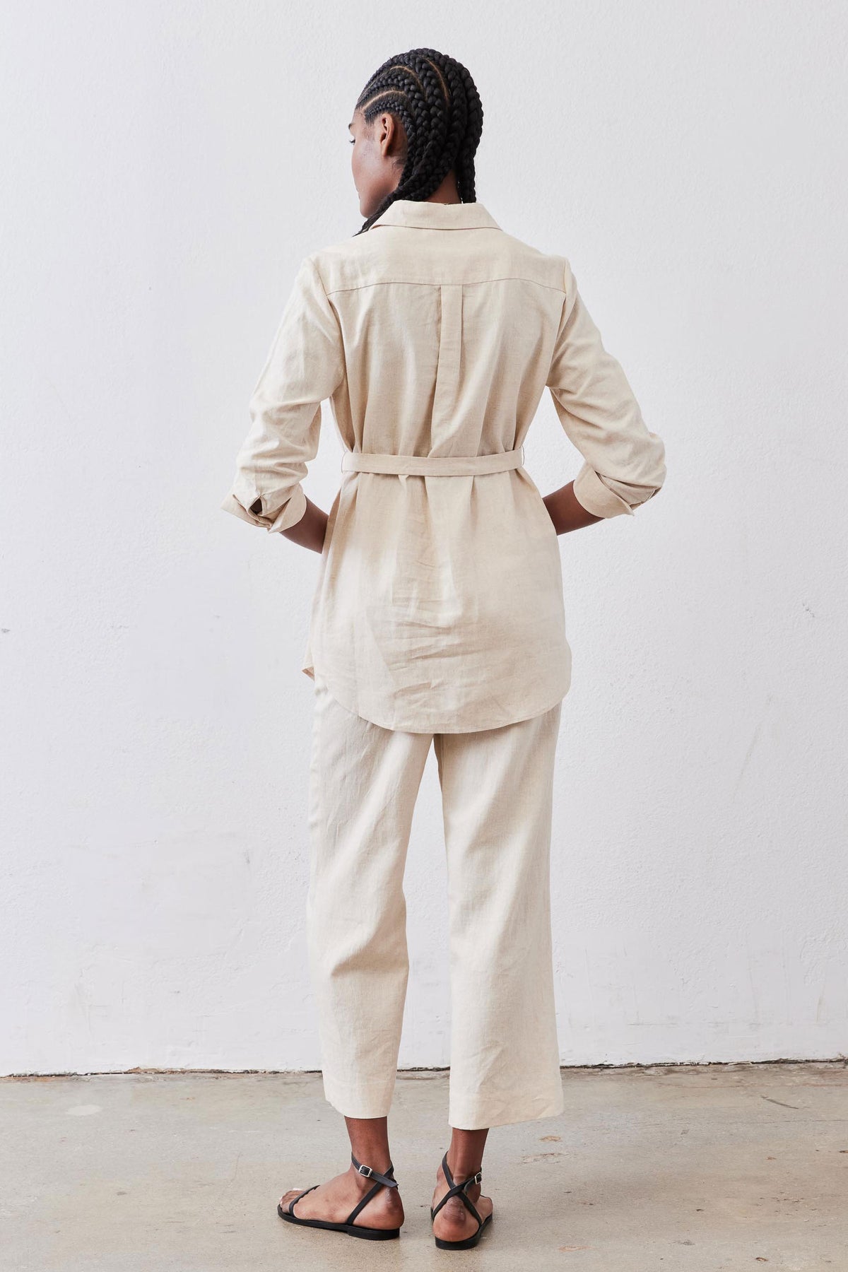 Oat linen belted tunic from back view with button placket and center pleat.