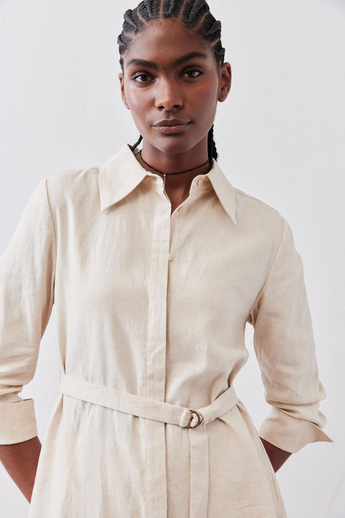 Oat linen belted tunic front view with button-front and pointed collar.