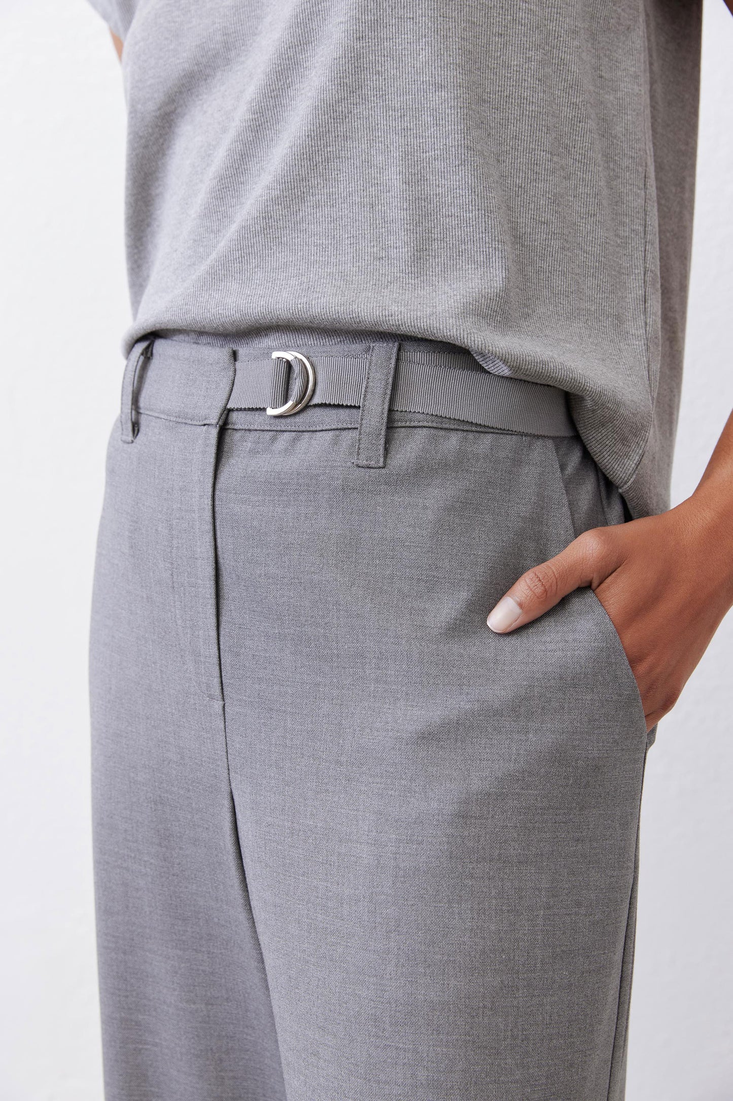 Close-up of belted pebble melange gray trousers with metal buckle and front pocket