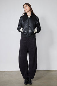 Black loose barrel corduroy pants with relaxed fit and tapered barrel legs