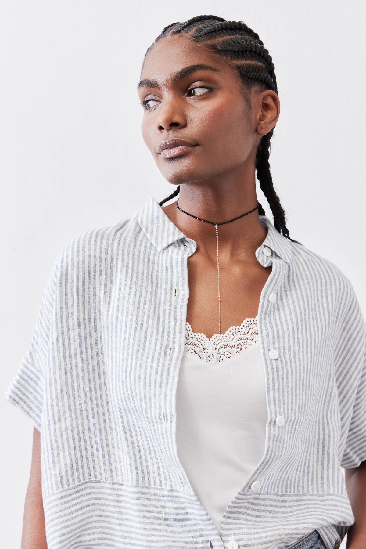 Boxy cropped linen blouse with blue pinstripes, button placket and short sleeves