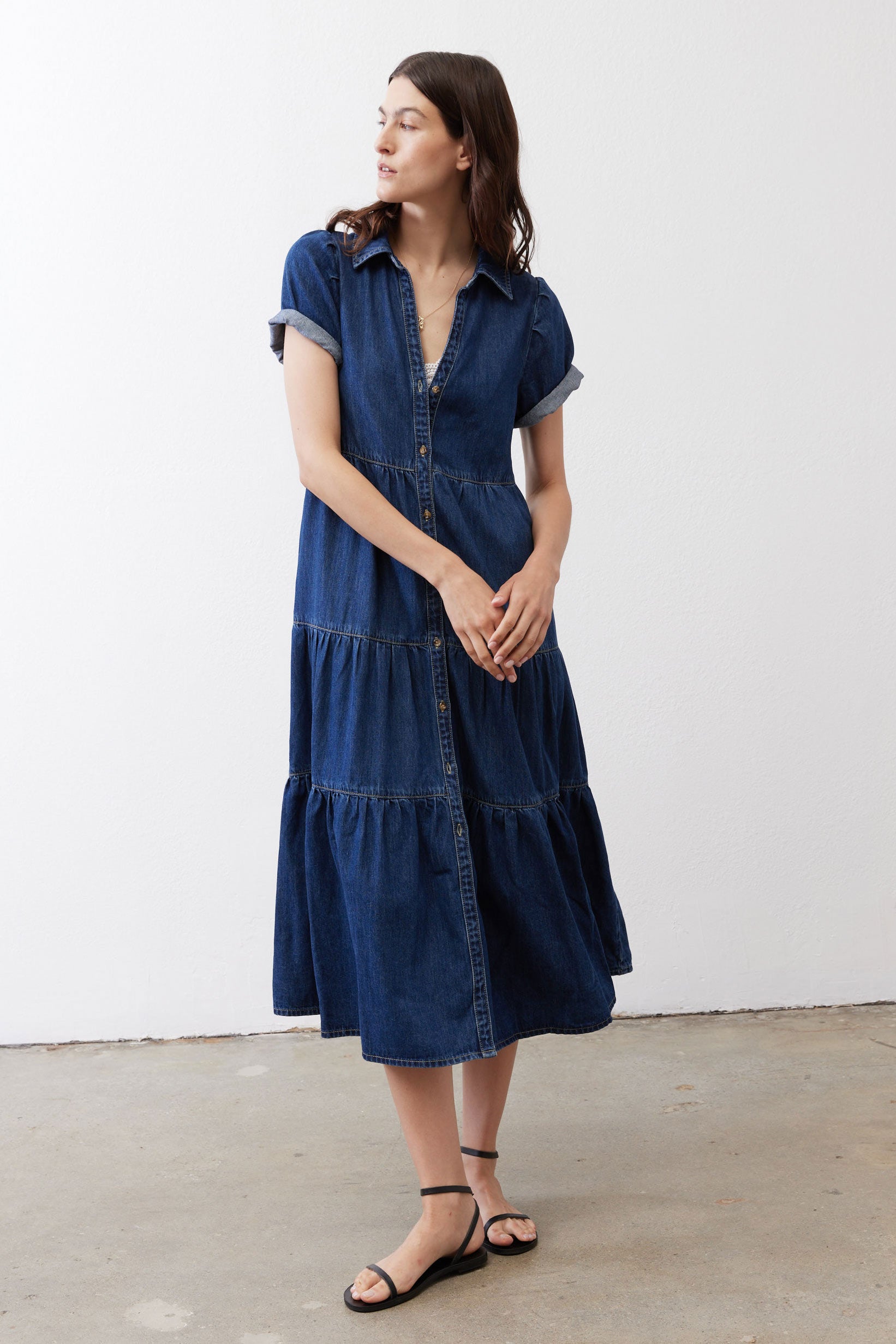 Medium-wash denim midi dress with short sleeves, button front, and tiered skirt