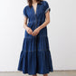 Medium-wash denim midi dress with collared button placket and tiered skirt
