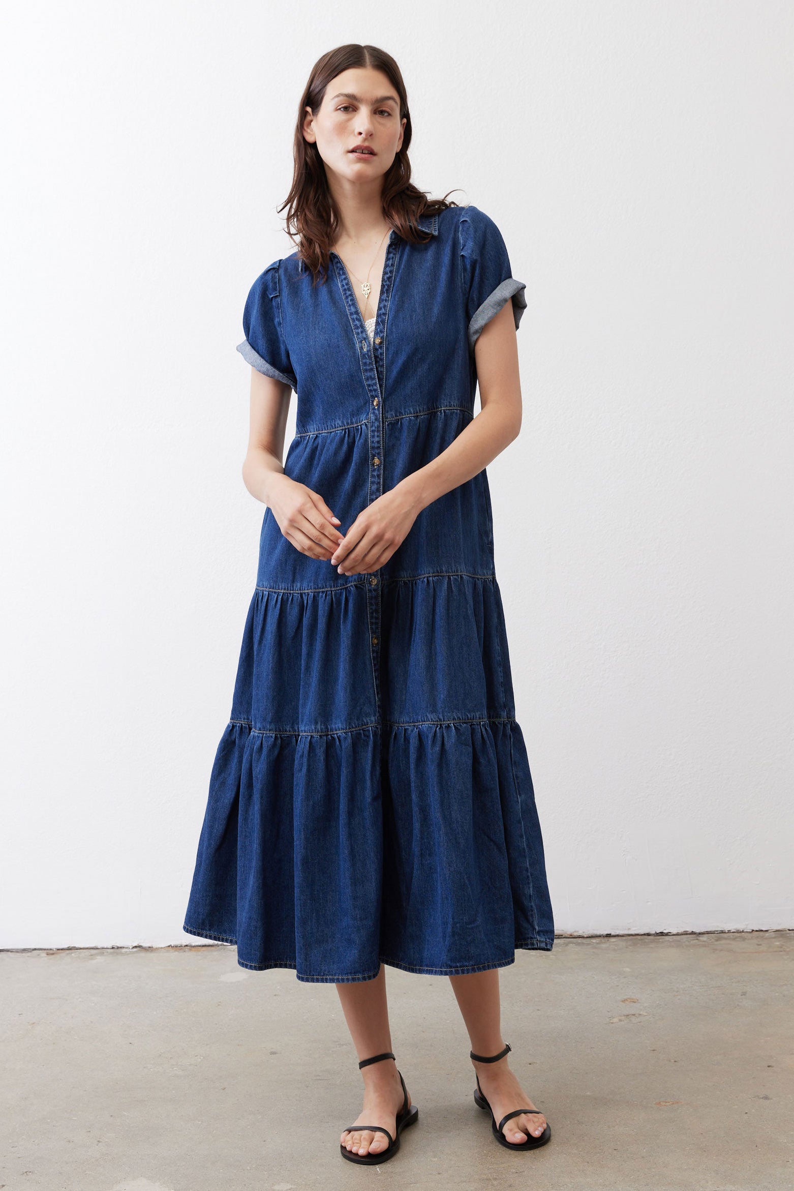 Medium-wash denim midi dress with collared button placket and tiered skirt